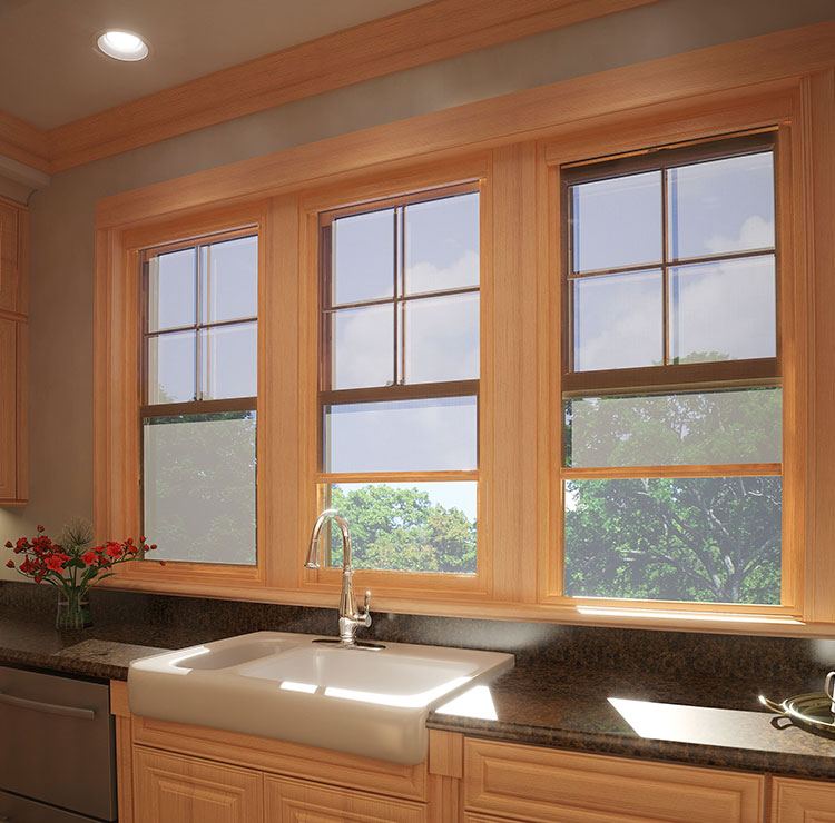 Farmhouse kitchen with triple wood-framed windows above farmhouse sink, featuring diamond-pattern backsplash and natural light